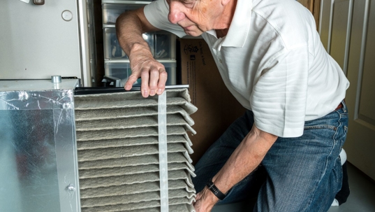 man looking at air filter