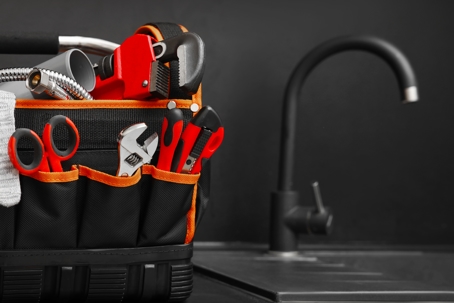 Plumber's tool bag on kitchen counter.