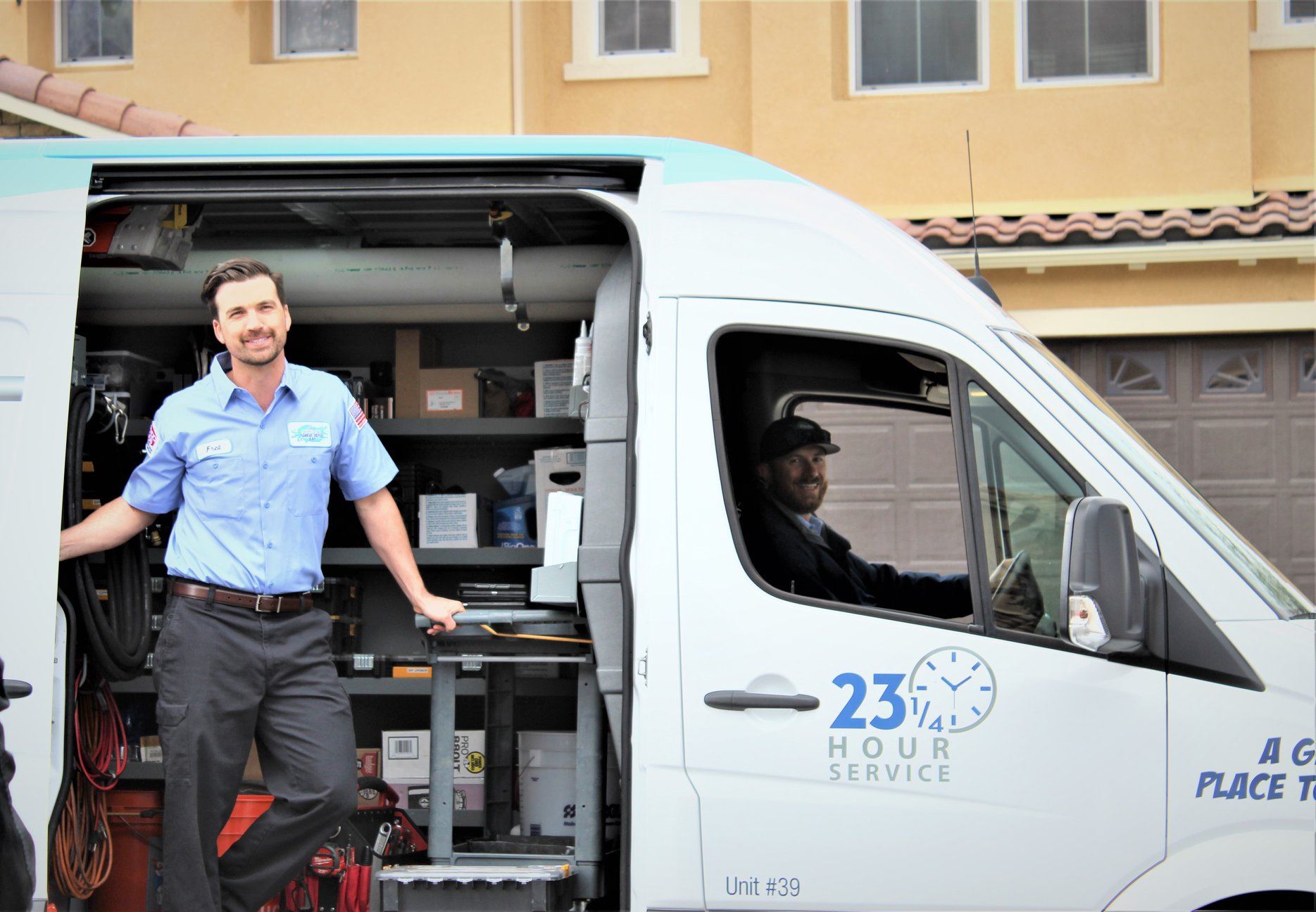 Technician standing by open truck door with tools